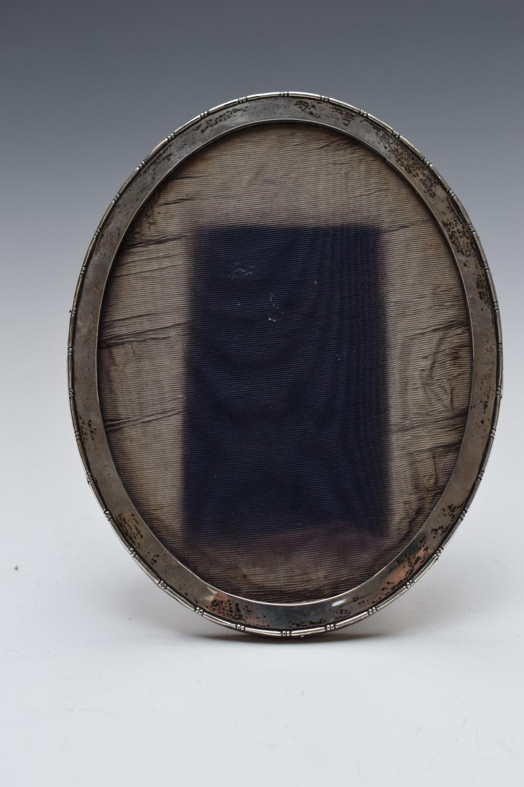 Oval hallmarked silver photograph frame with oak easel back, Birmingham 1921, maker's mark