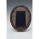 Oval hallmarked silver photograph frame with oak easel back, Birmingham 1921, maker's mark