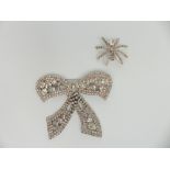 A vintage bow brooch set with diamanté and a vintage brooch in the form of a spider set with paste