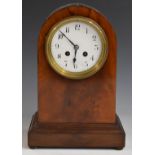 A c1900 mahogany carved arch top mantel clock, the anonymous two train movement stamped 3000, 52,