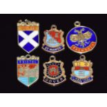 Six 9ct gold enamel charms including 'Bristol', 'Weston Super Mare', 'Scotland', 'Falmouth', 'St