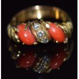 An 18ct gold ring set with three round cut diamonds and two coral cabochons, 5.2g, size L