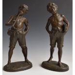 Pair of spelter figures of boys, one with books, the other with a horn, H33cm