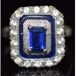 An 18ct white gold ring set with an emerald cut synthetic sapphire and paste, 3.7g, size N