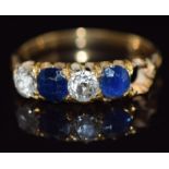 A c1900 18ct gold ring set with cushion cut sapphires each approximately 0.4cts and round cut