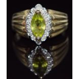 A 9ct gold ring set with a marquise cut peridot surrounded by diamonds, 4.0g, size R