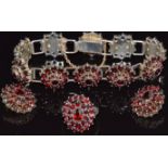 A silver gilt suite of jewellery set with Bohemian cut garnets comprising bracelet, earrings & ring