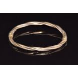 A 9ct gold bangle with twisted ridged decoration, 6.3g