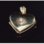 A 9ct gold locket set with a diamond, 1.4g