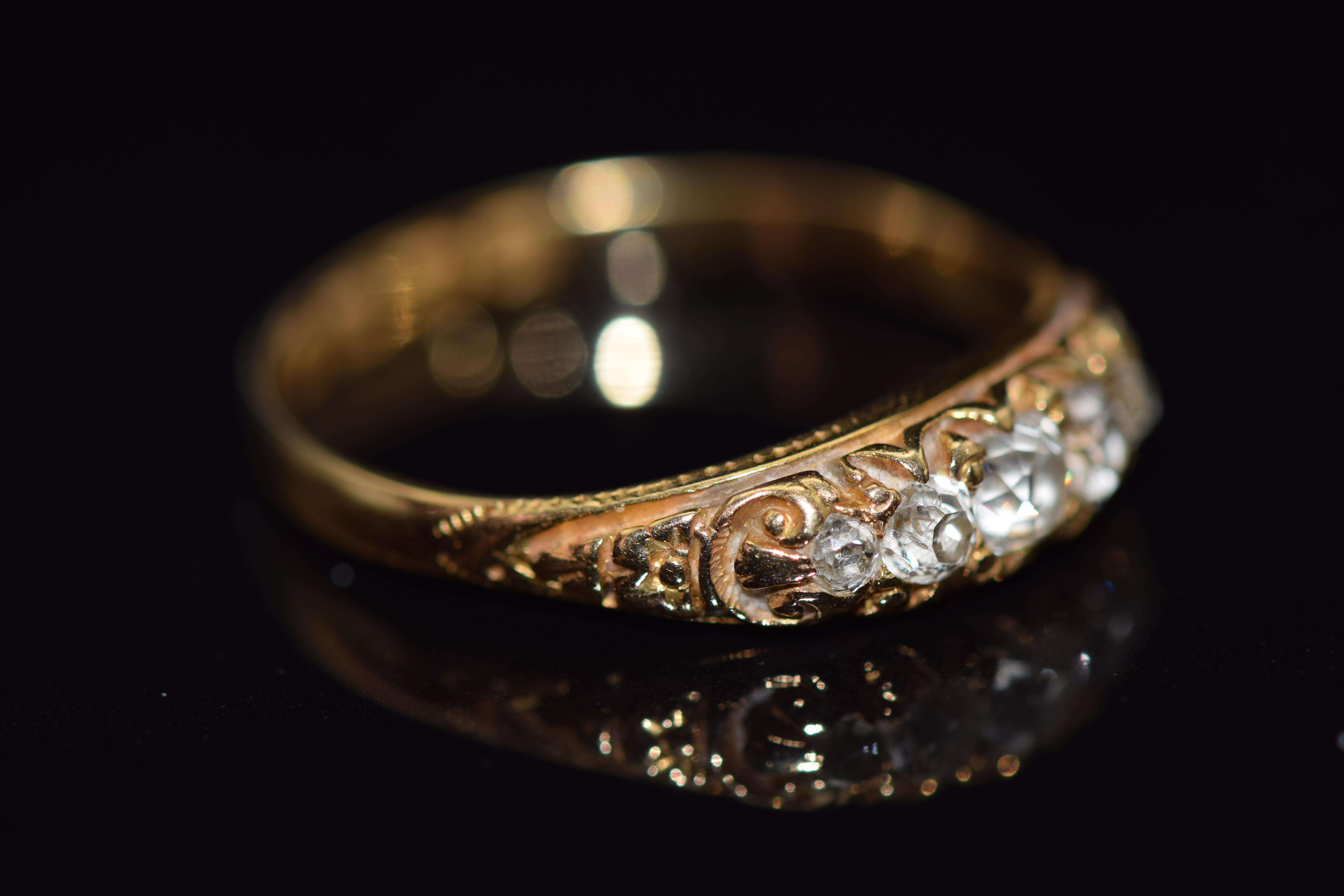 An 18ct gold ring set with five old cut diamonds in a scrolling setting, Birmingham 1922, 2.6g, size - Image 2 of 3