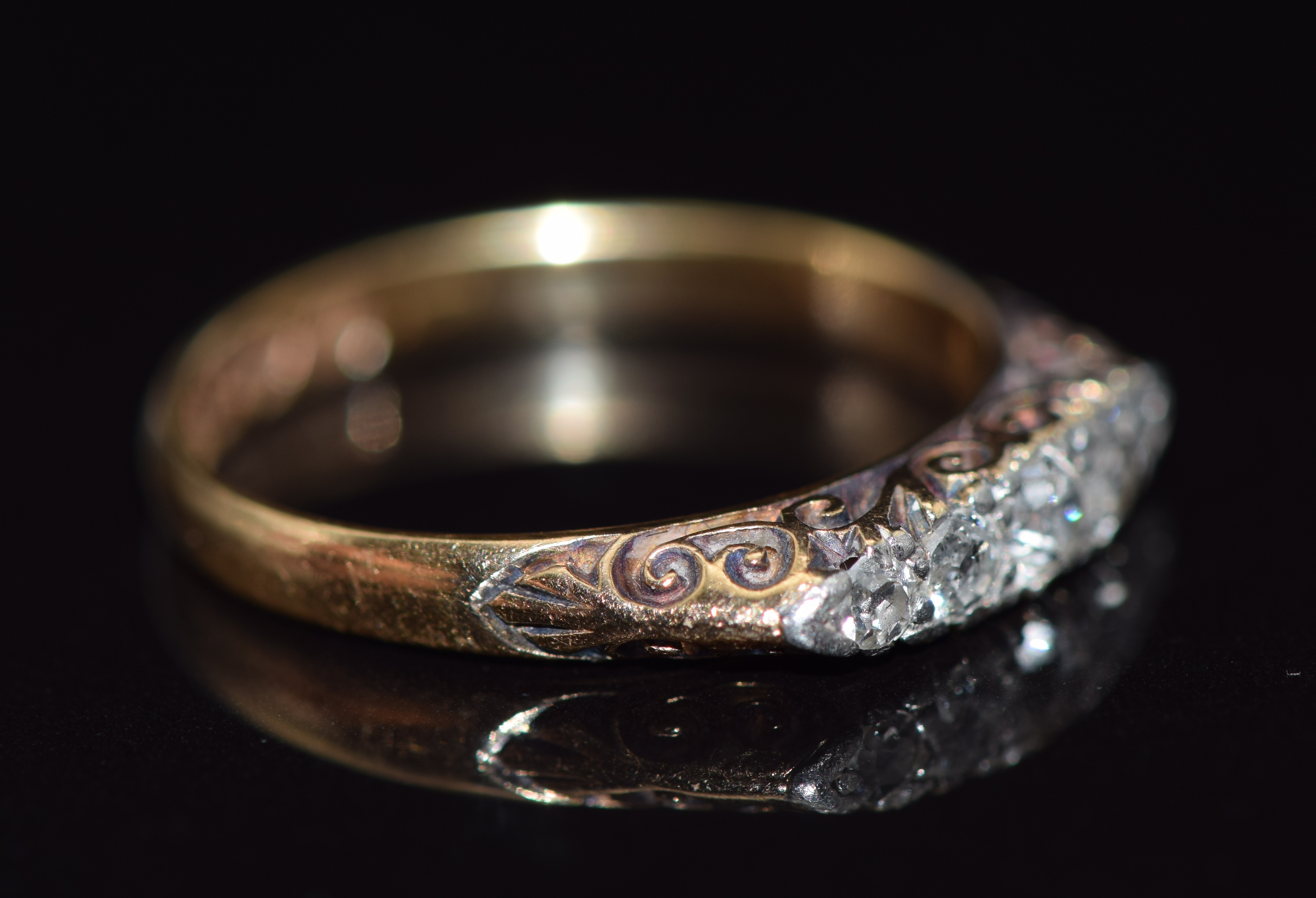 An 18ct gold ring set with five diamonds in a scrolling setting, 2.8g, size N - Image 2 of 2