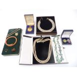 A collection of costume jewellery including two silver brooches, Art Deco snake bangle, necklaces