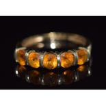A 9ct gold ring set with five round cut citrines, 1.9g, size N