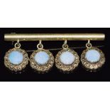 A 9ct gold bar brooch set with opal doublets and marcasite, 10.4g, 5cm long