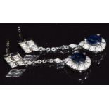A pair of 18ct white gold earrings set with a pear cut sapphire and diamonds, 3.1g