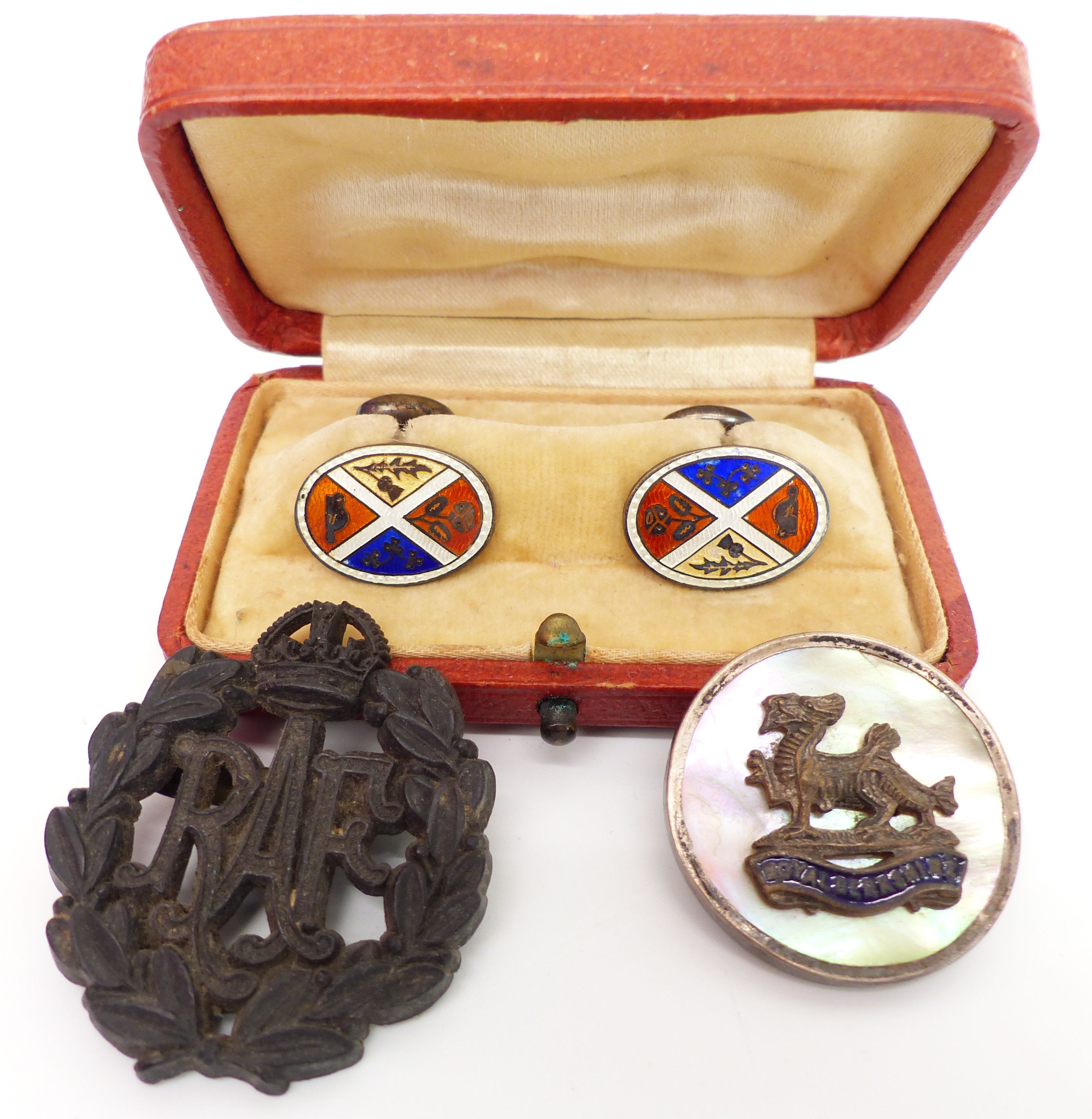 A pair of silver cufflinks set with enamel, an RAF brooch, and an RAF badge