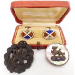 A pair of silver cufflinks set with enamel, an RAF brooch, and an RAF badge