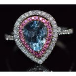 An 18ct white gold ring set with a pear cut aquamarine surrounded by pink sapphires and diamonds,