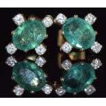A pair of 9ct gold earrings set with oval cut emeralds, each approximately 1ct and four diamonds