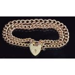 A 9ct gold double strand curb link bracelet made from a Victorian fob chain, with heart padlock,