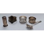 Three hallmarked silver napkin rings, hallmarked silver sifter spoon and a Tiffany pepper marked