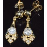 A pair of 14ct gold earrings set with diamonds of approximately 0.71ct & 0.78ct, with certificates