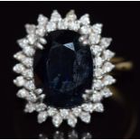An 18ct gold ring set with a large oval cut sapphire surrounded by diamonds, 8.4g, size N/O1