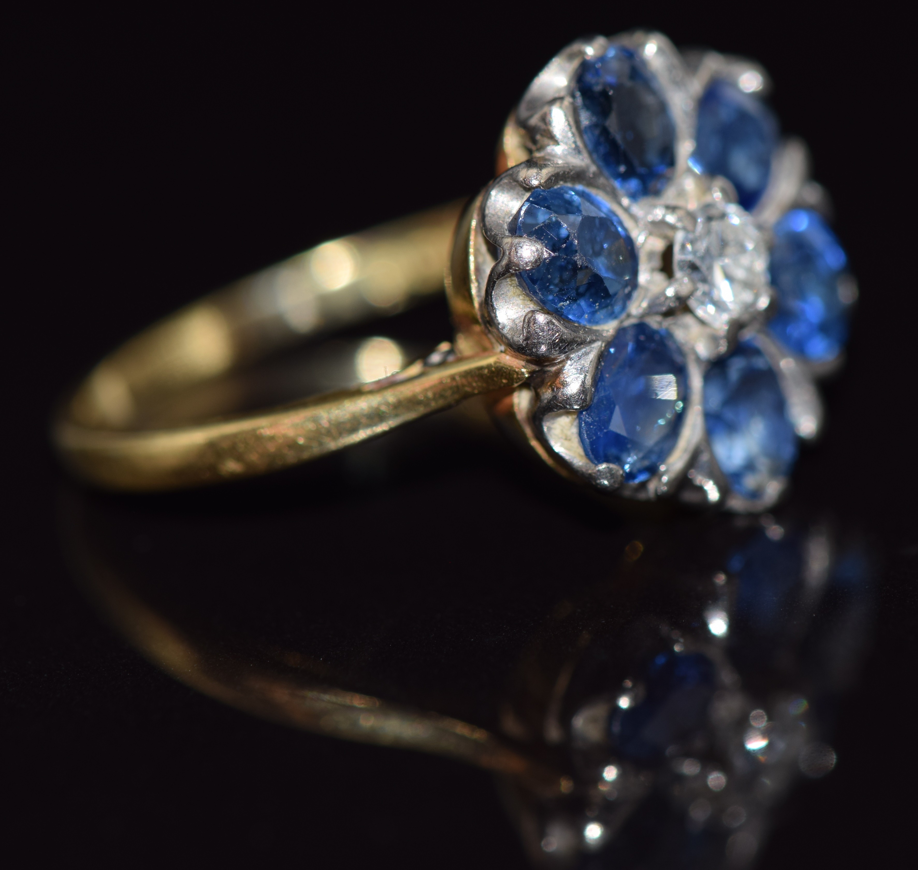 An 18ct gold ring set with a diamond surrounded by oval cut sapphires, each approximately 0.3cts, - Image 2 of 2