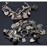 Two silver charm bracelets with over 30 charms including thistle, car, anchor, acorn, elephant,