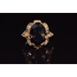 A 9ct gold ring set with an oval cut smoky quartz, 4.8g, size K/L