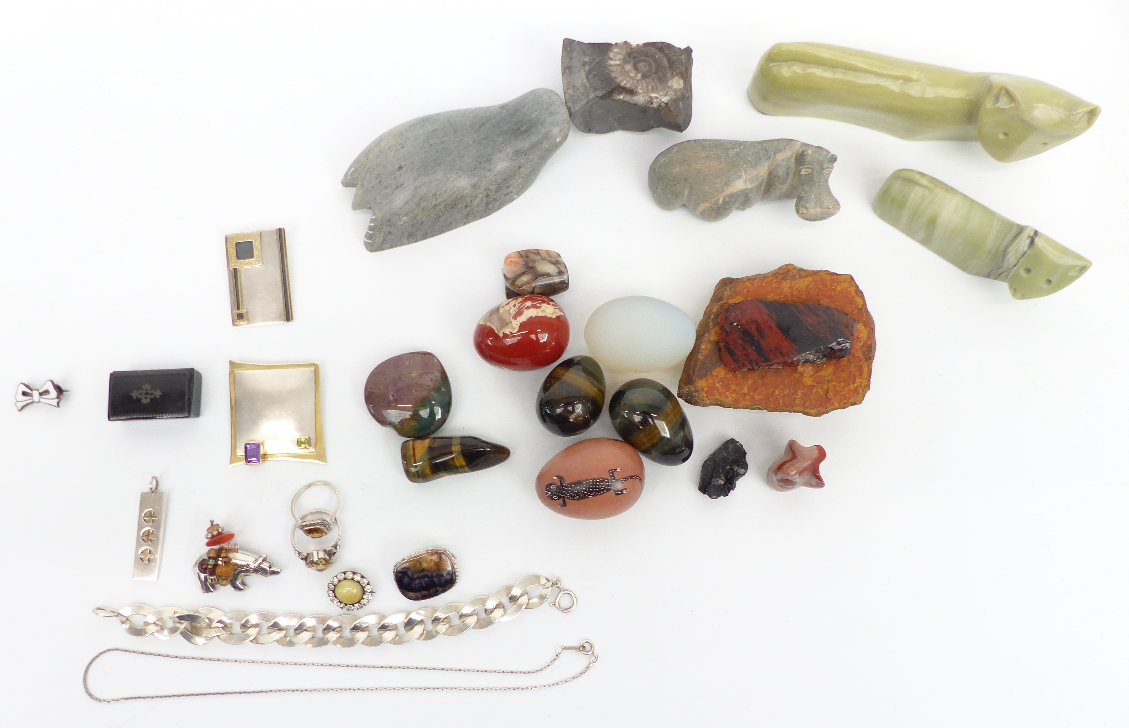 A collection of jewellery including suffragette brooch, silver brooches, one set with an amethyst