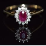 A 9ct gold ring set with an oval cut ruby and diamonds, 2.2g, size Q