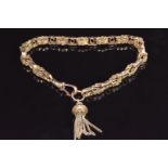 A 9ct rose gold Victorian bracelet made from a fob chain with embossed and pierced links with tassel