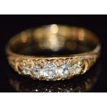 An 18ct gold ring set with five old cut diamonds in a scrolling setting, Birmingham 1922, 2.6g, size