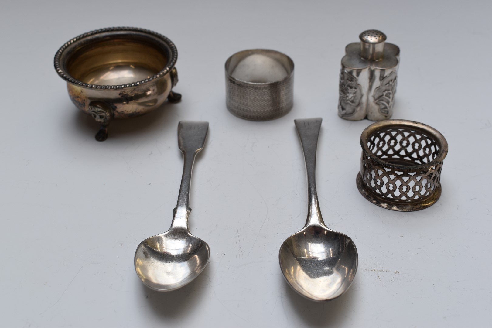 Two hallmarked silver dessert spoons, open salt marked sterling, two hallmarked silver napkin