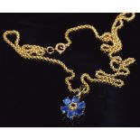 A 9ct gold pendant set with a yellow sapphire and blue sapphires forming a flower cluster, 9.4g