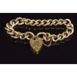 A 9ct gold curb link bracelet with alternating textured links and a heart padlock, 19g