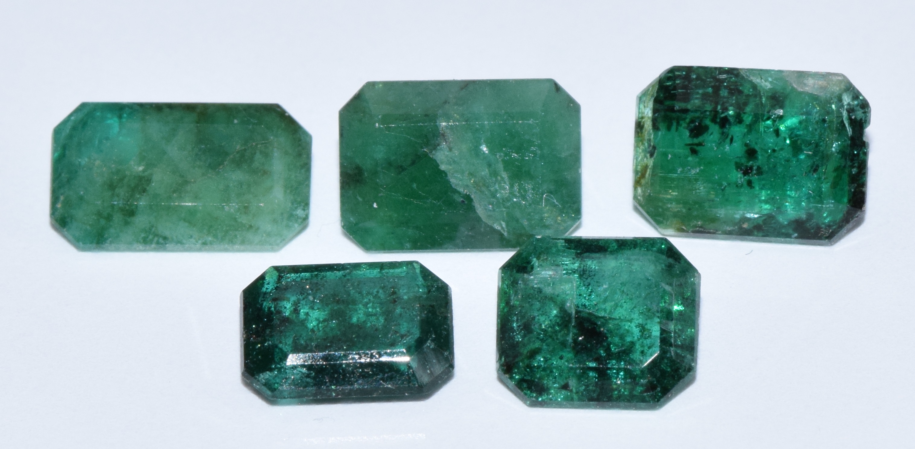 Five loose emerald cut emeralds, total 5.5ct