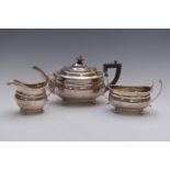 George V hallmarked silver three piece teaset with gadrooned edge, raised on four ball feet,