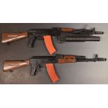 Two airsoft BB guns both in the style of an AK47 machine gun, one with grenade launcher.