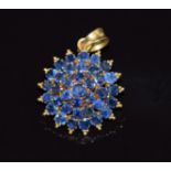 An 18ct gold pendant set with set with sapphires in a cluster, 2.5cm x 1.8cm