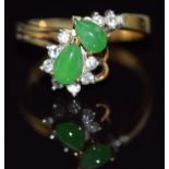 A 14k gold ring set with two pear cut jade cabochons and diamonds, 3.2g, size K