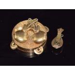 A yellow metal charm in the form of a tambourine and a yellow metal charm in the form of a mandolin,