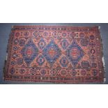 Turkoman rug decorated with three large blue guls on a wine ground, 310 x 192cm