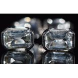 A pair of 18ct white gold earrings set with an emerald cut aquamarine to each, 2.3g