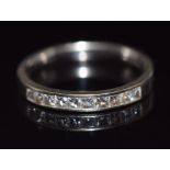 An 18ct white gold half eternity ring set with 10 princess cut diamonds, 3.6g, size N