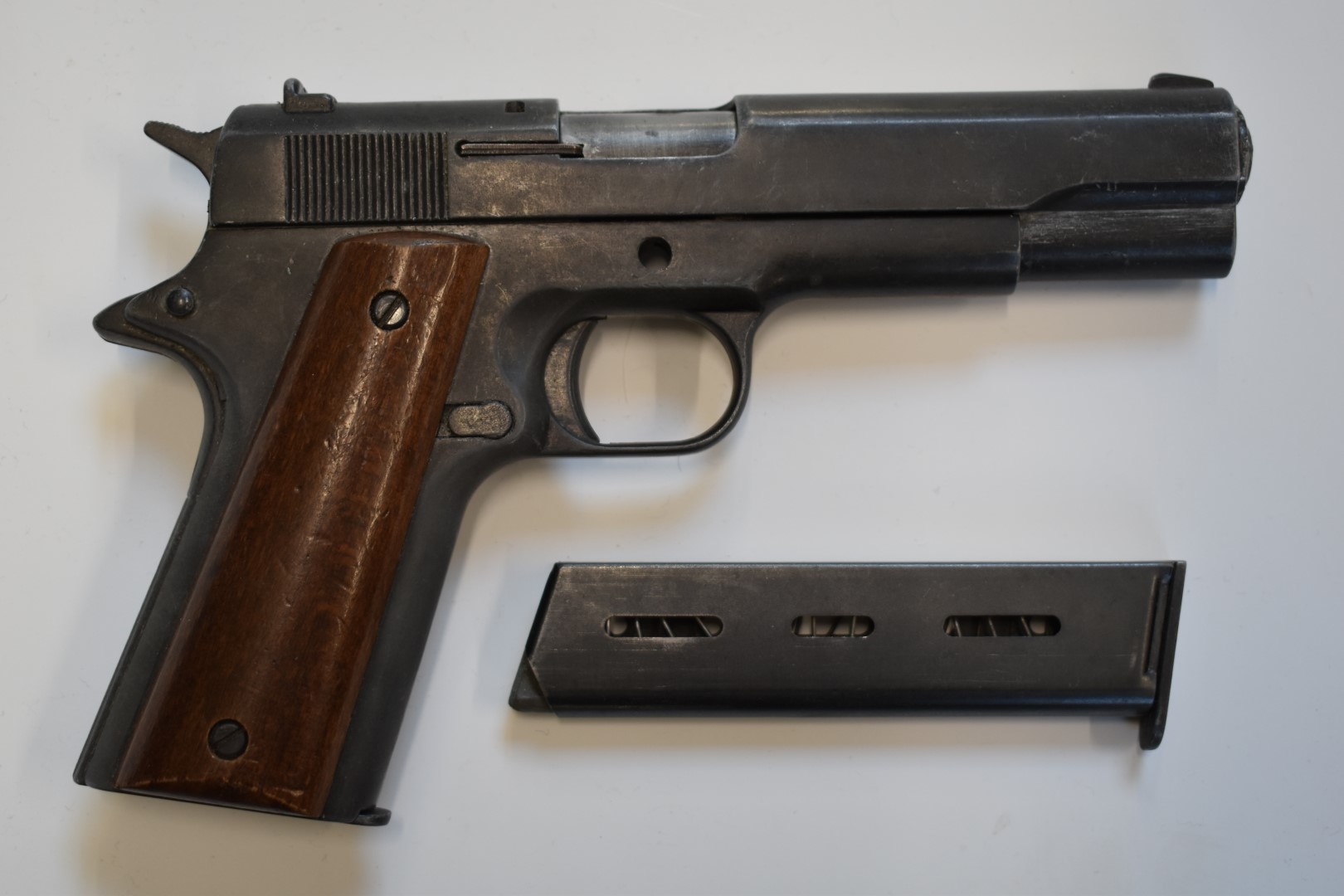 BBM Bruni 96 Automatic 8mm blank firing pistol with wooden grips and a spare magazine.