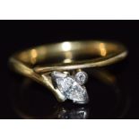 An 18ct gold ring set with a marquise cut diamond of approximately 0.27ct and a round cut diamond,