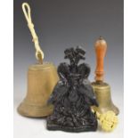 Brass hand bell, hanging bell and a cast iron door porter with bird decoration and impressed 'Cannon