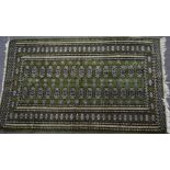Turkoman rug on green ground, 150 x 90cm